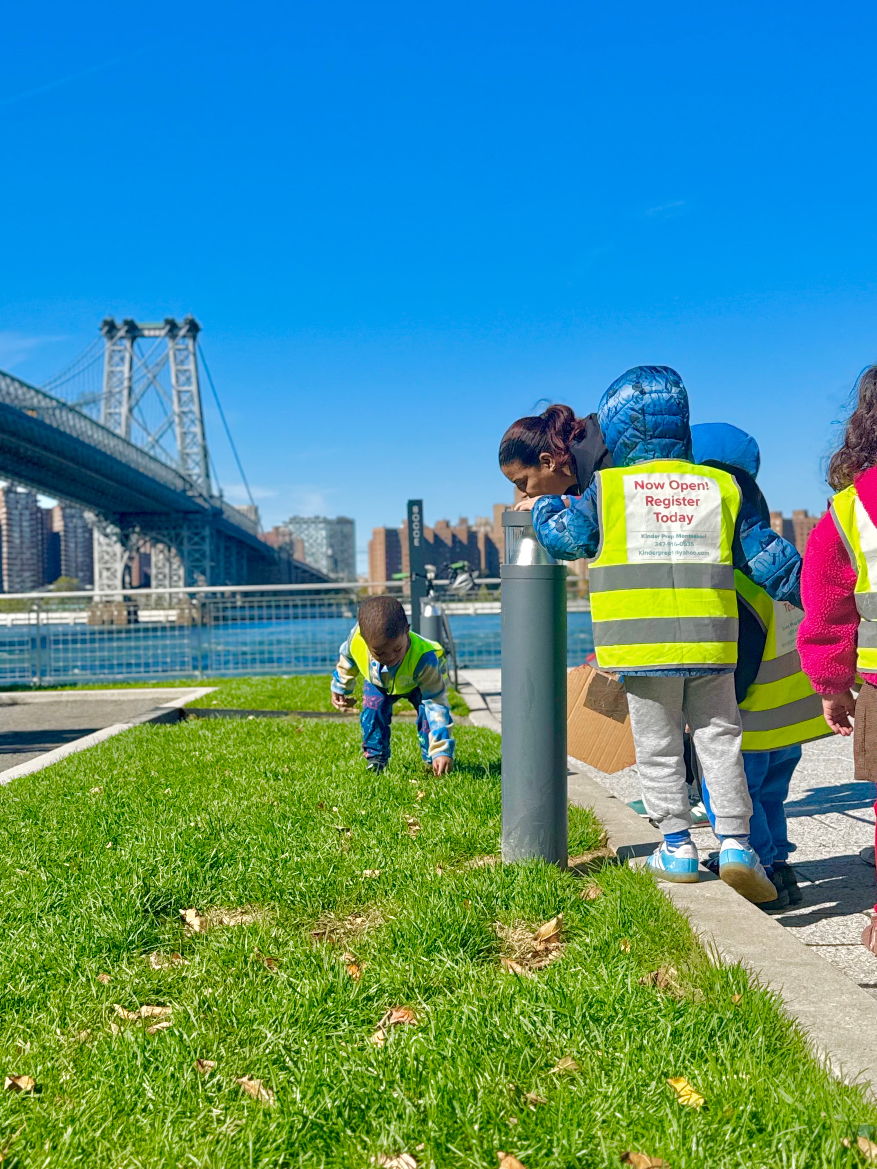 Children exploring the waterfront beneath the bridge