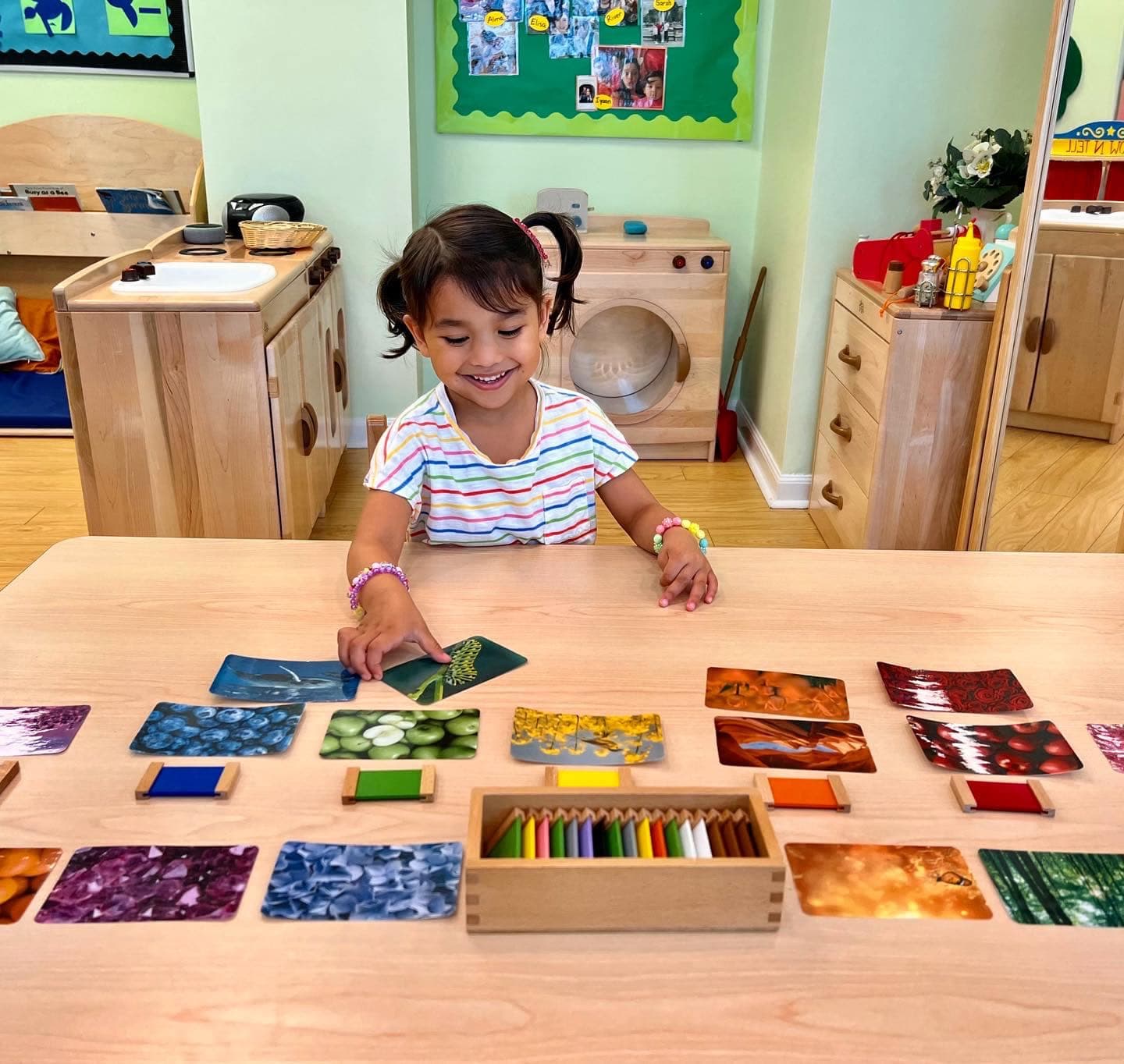 Early preschooler matching Montessori color tablets to nature photo cards