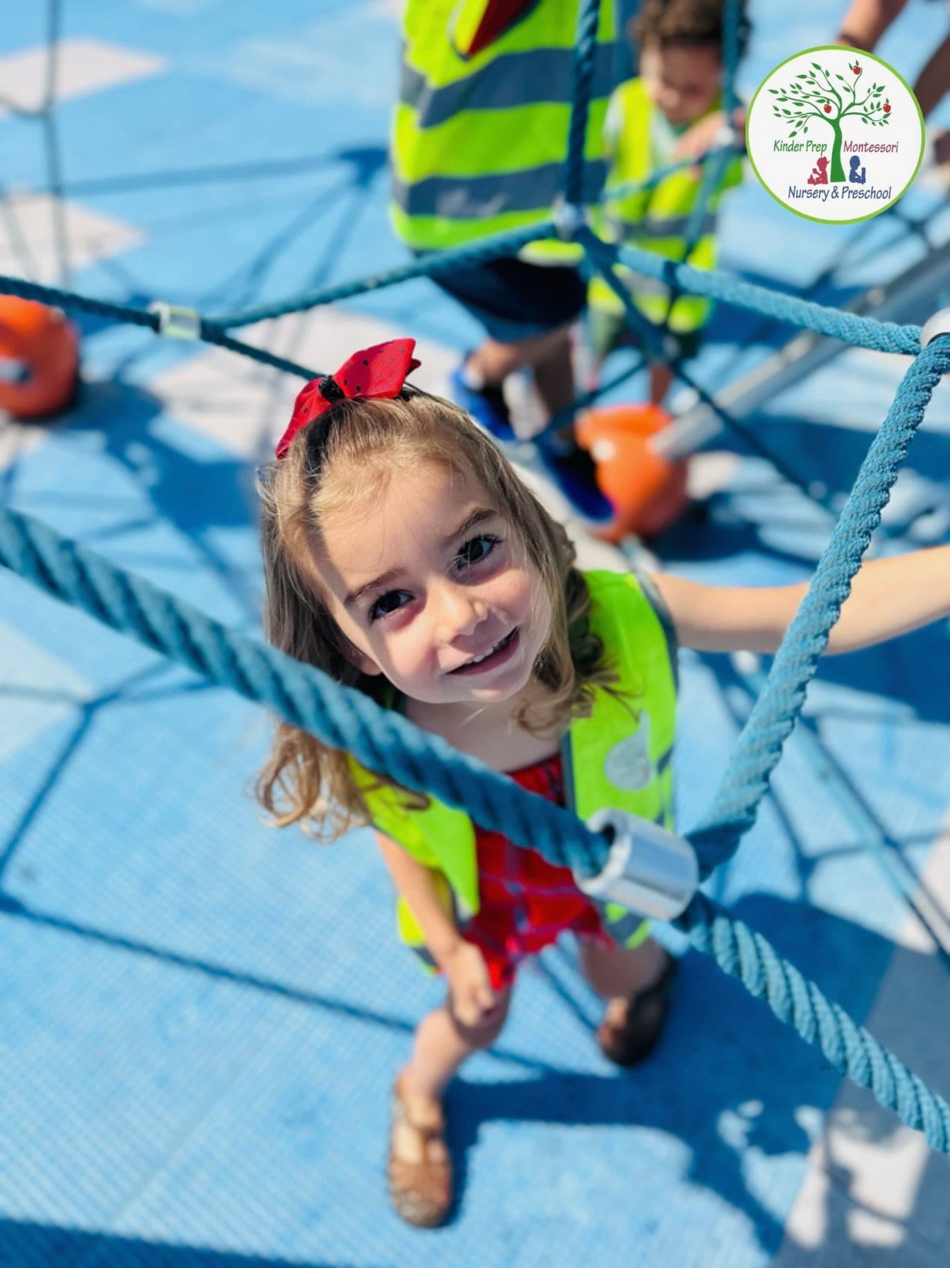 Girl climbing on rope playground