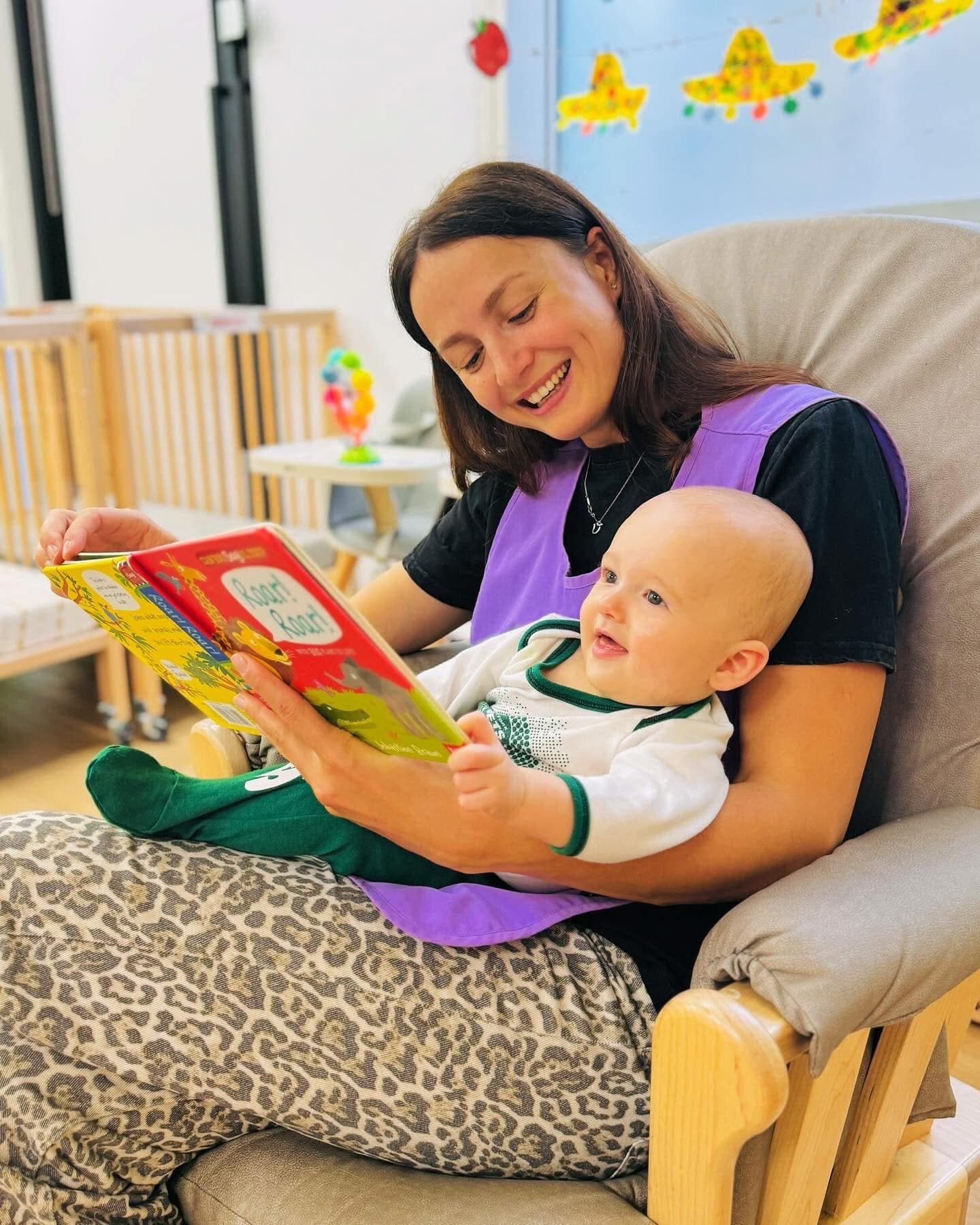 Teacher reading warmly with infant