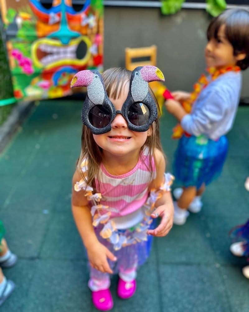 Girl enjoying summer party with toucan sunglasses